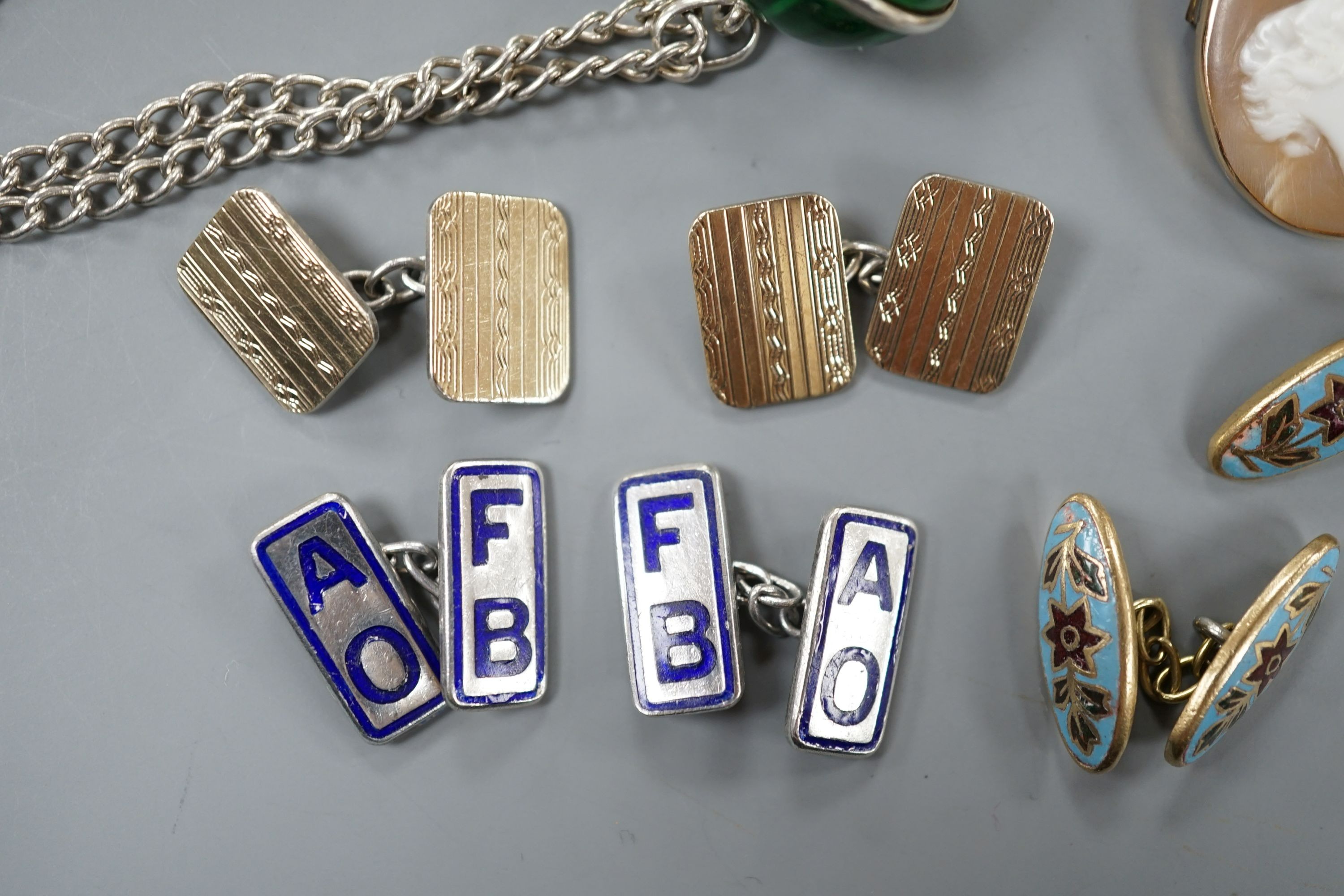 An early 20th century French white and yellow metal, green enamel(a.f.) set pomander, 19mm, on a white metal chain, three French (18ct poincon mark) and baroque pearl set dress studs, gross 3.5 grams, a diamond set 15ct